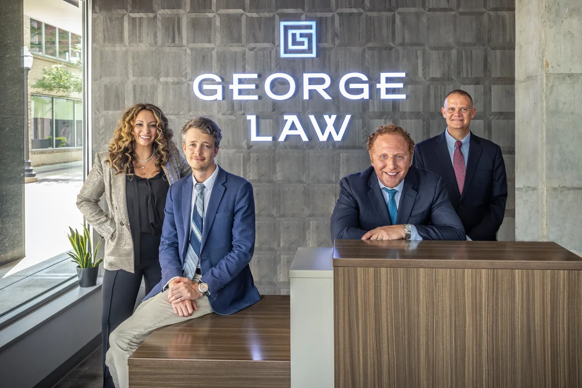 Michigan criminal defense & DUI lawyers standing at the front desk of their George Law, a law firm located in Royal Oak.